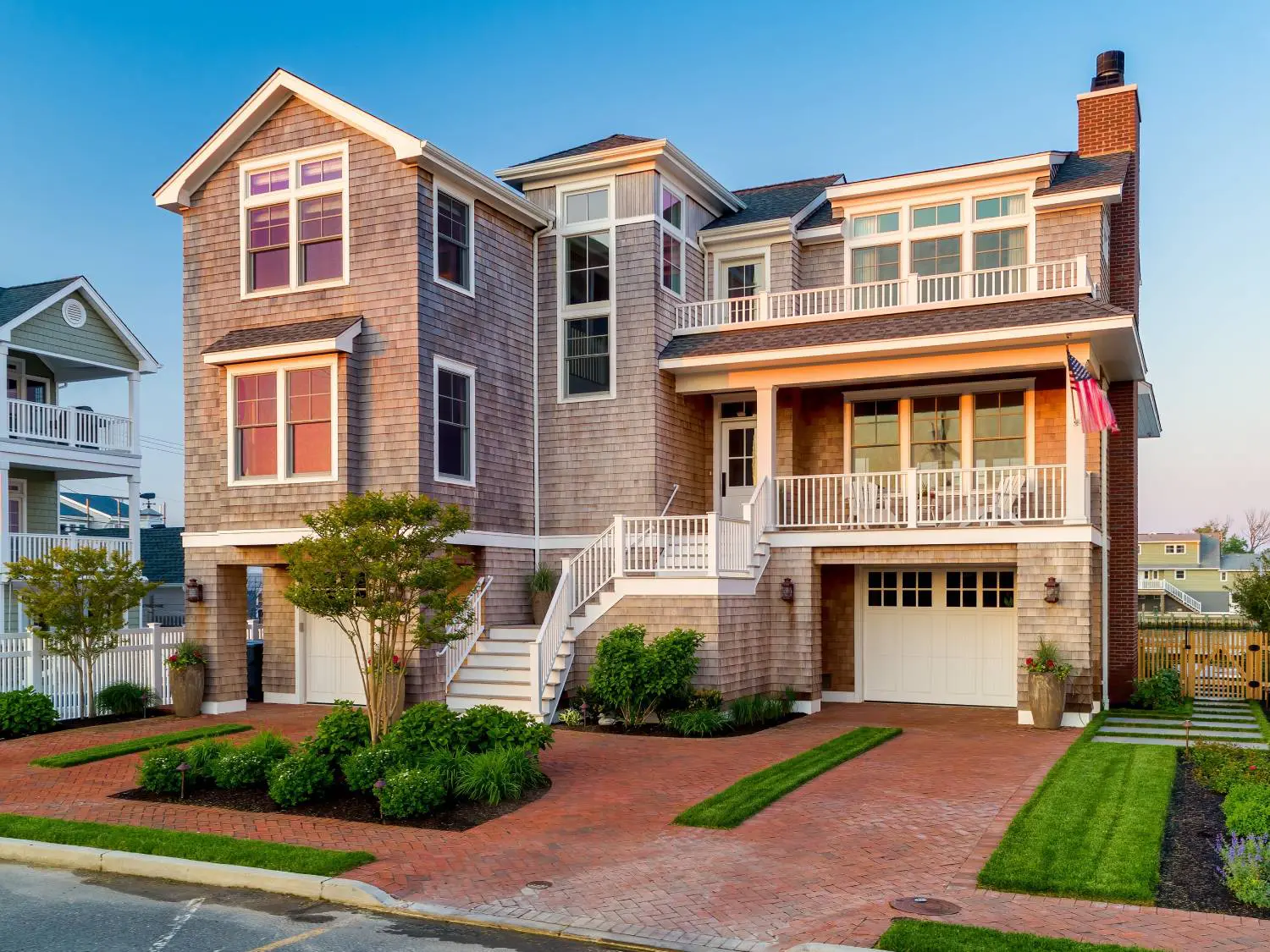 A large house with a driveway and lawn.