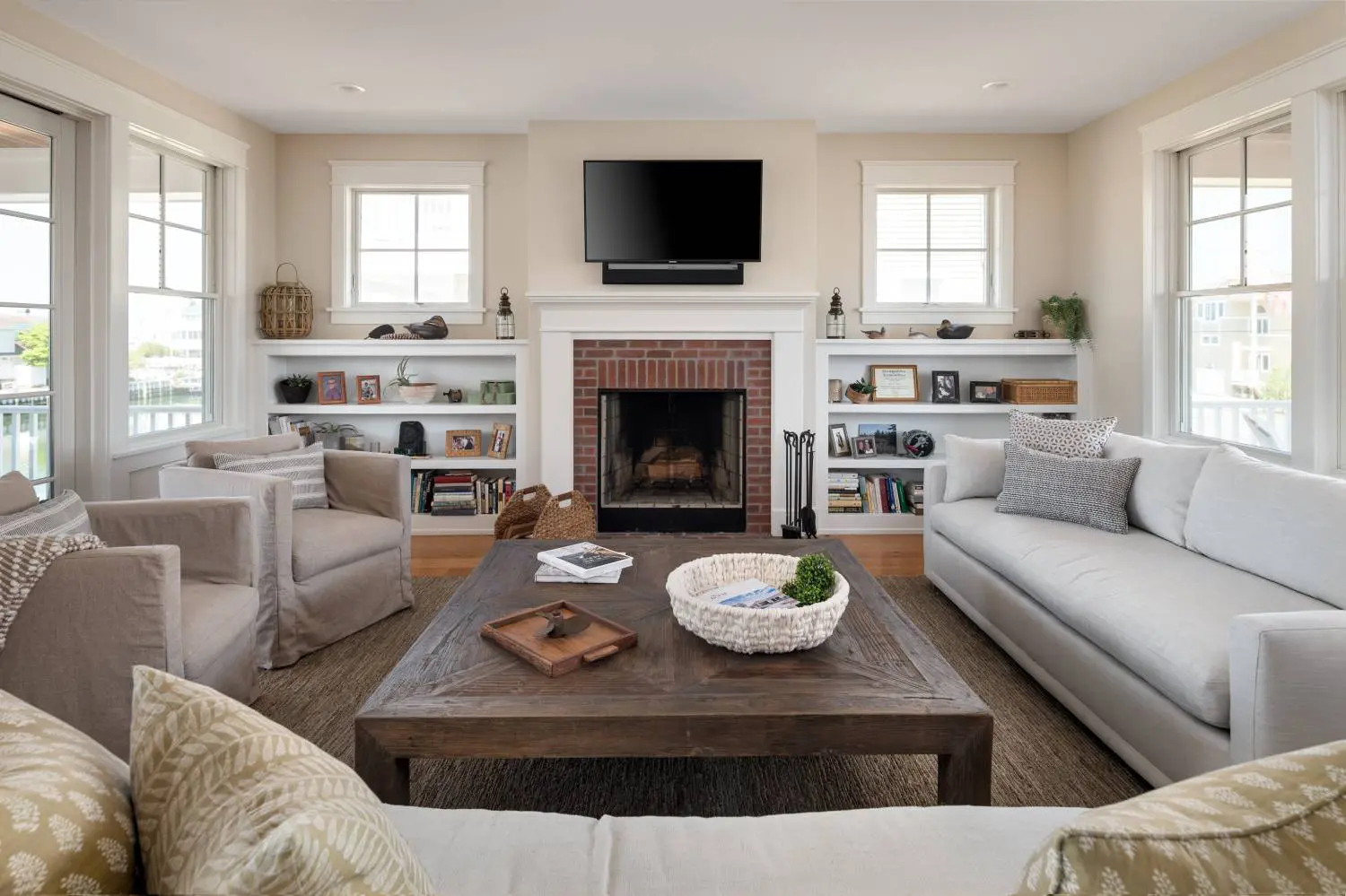 A living room with couches, chairs and a fireplace.