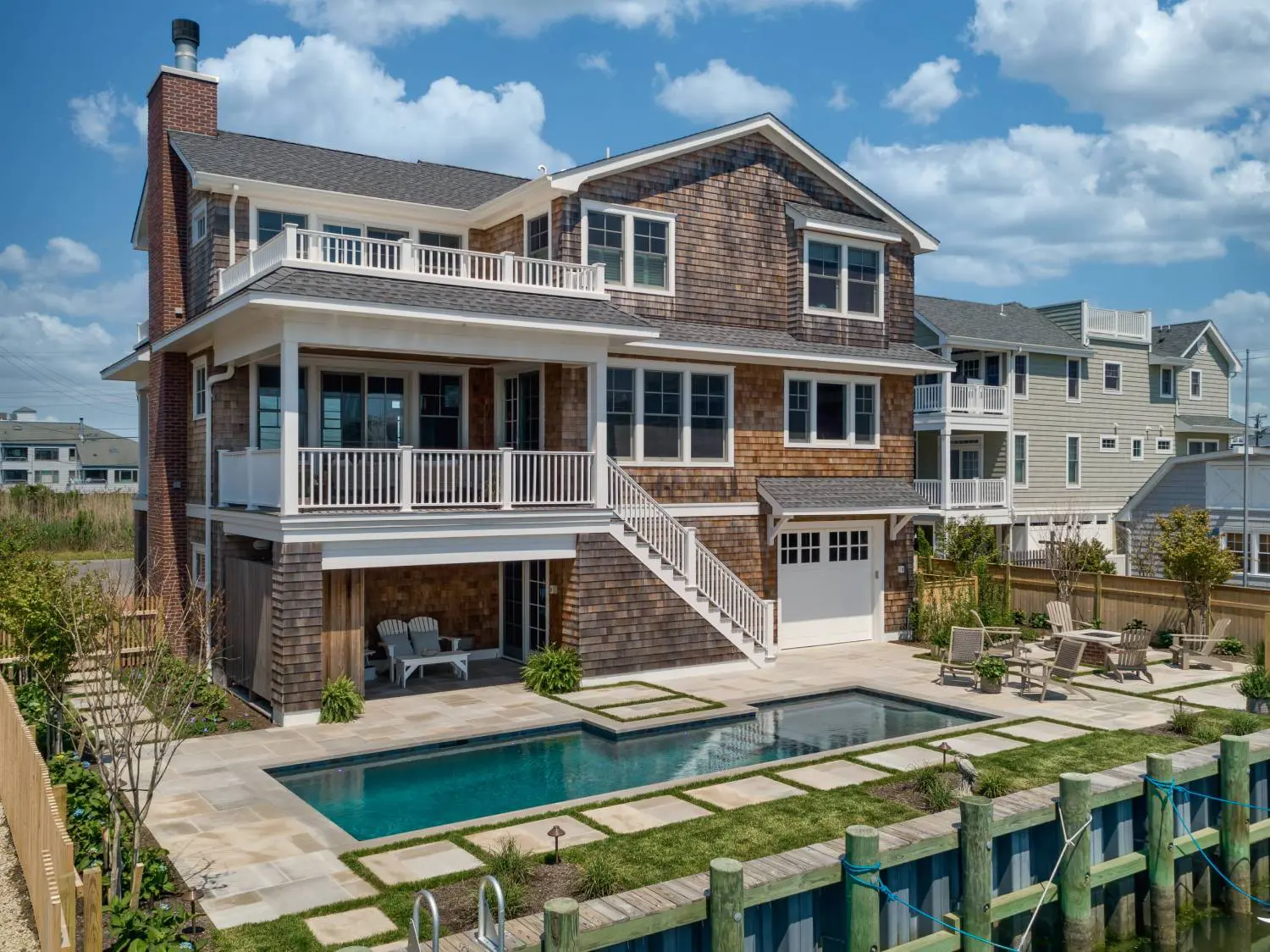 A large house with a pool and deck in the back.