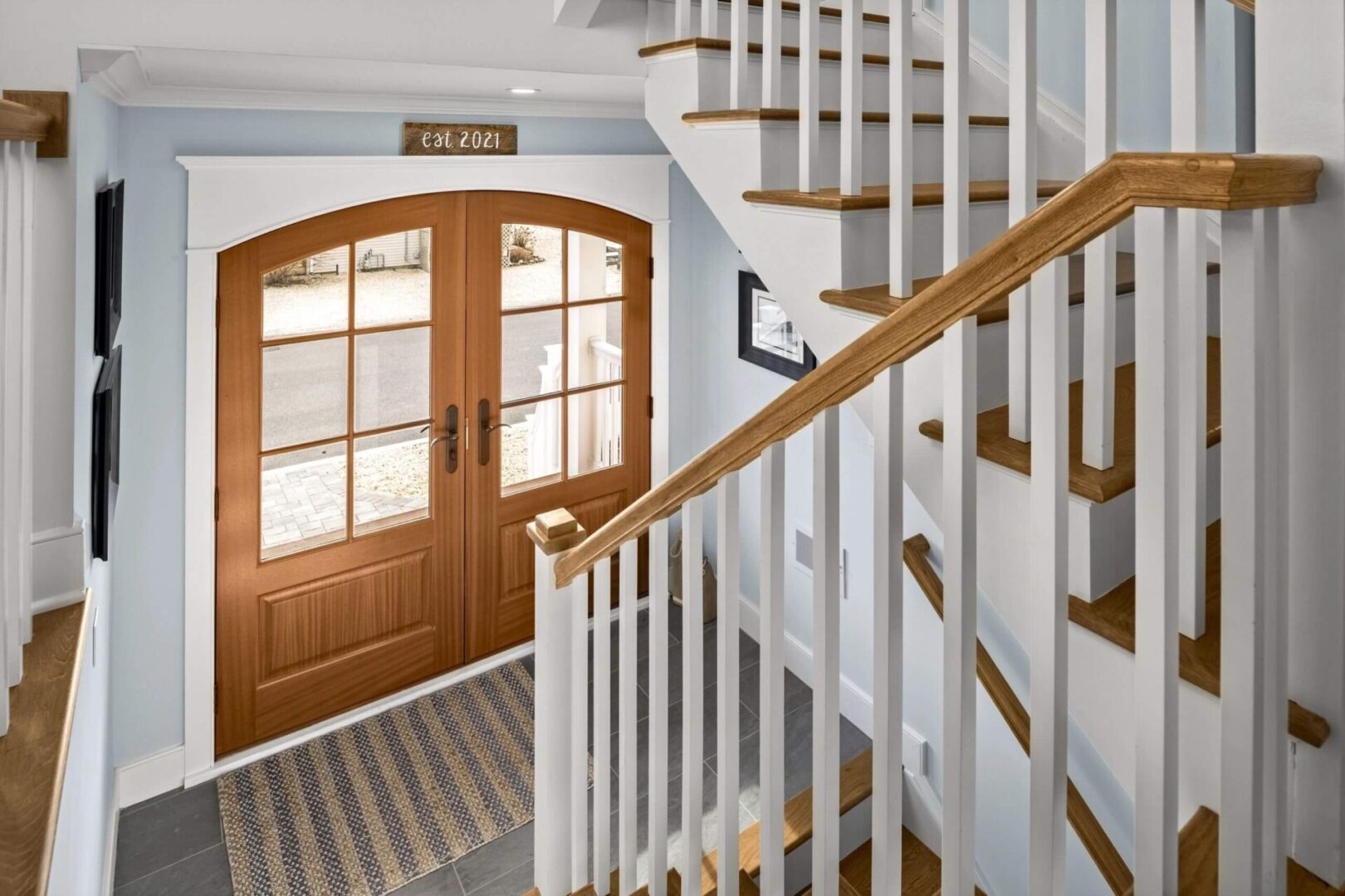 A staircase with wooden steps and white railings.