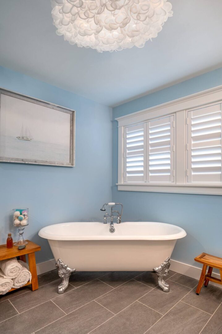 A bathroom with a tub and window in it