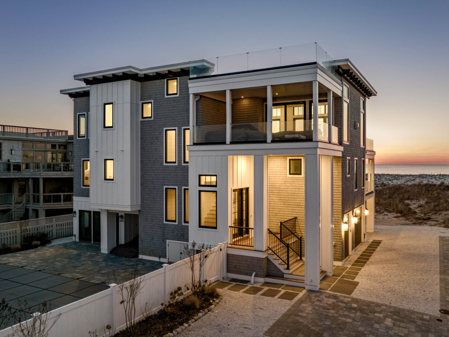 A modern house with an open porch and balcony.