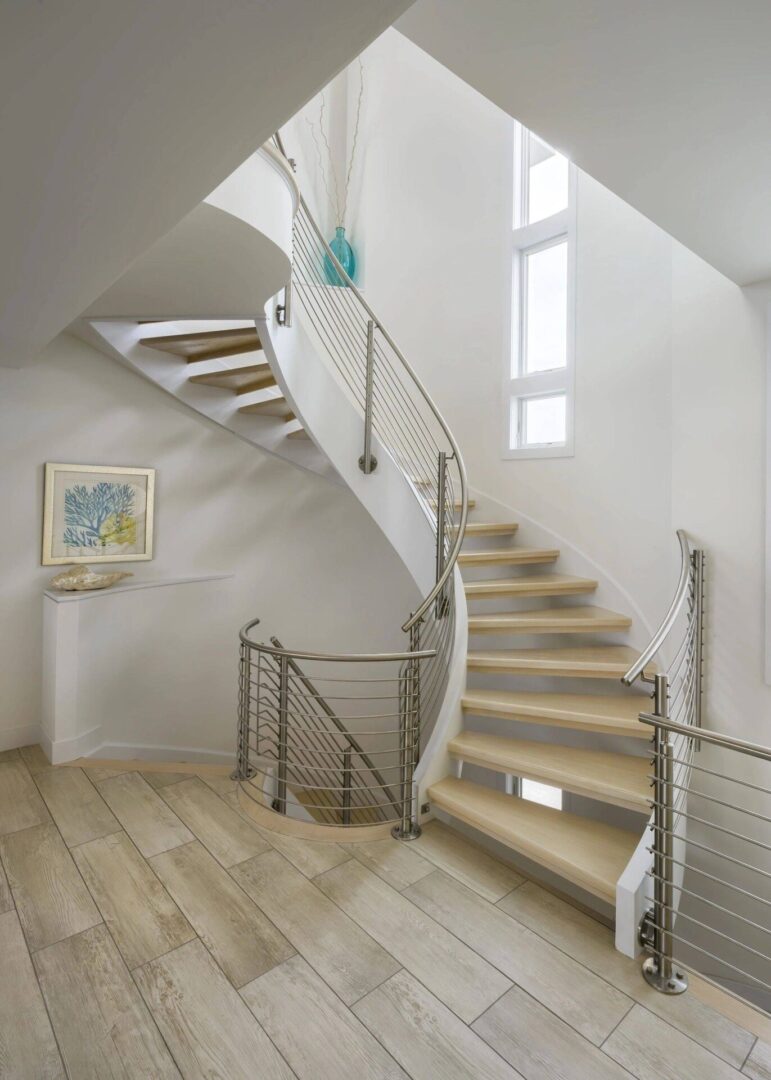 A staircase with metal railing and wood steps.