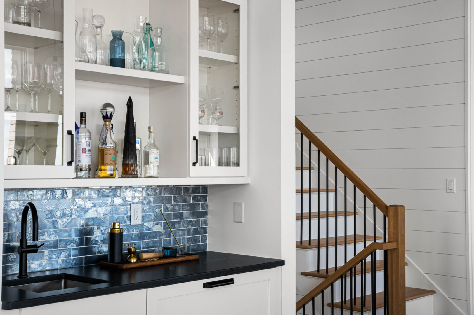 A kitchen with a bar and shelves in it