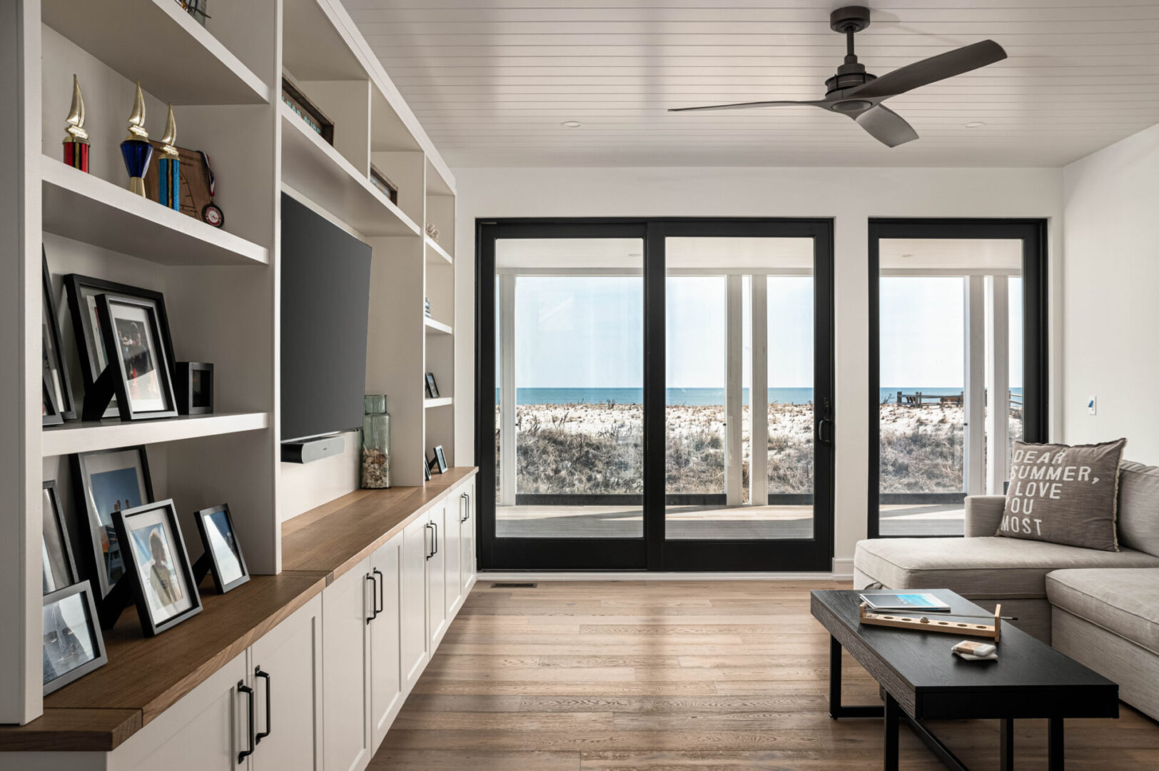 A living room with a view of the beach.