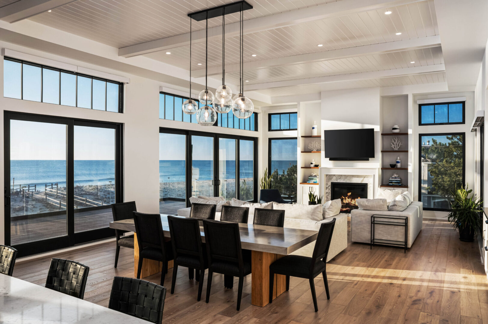 A dining room with a large table and chairs.