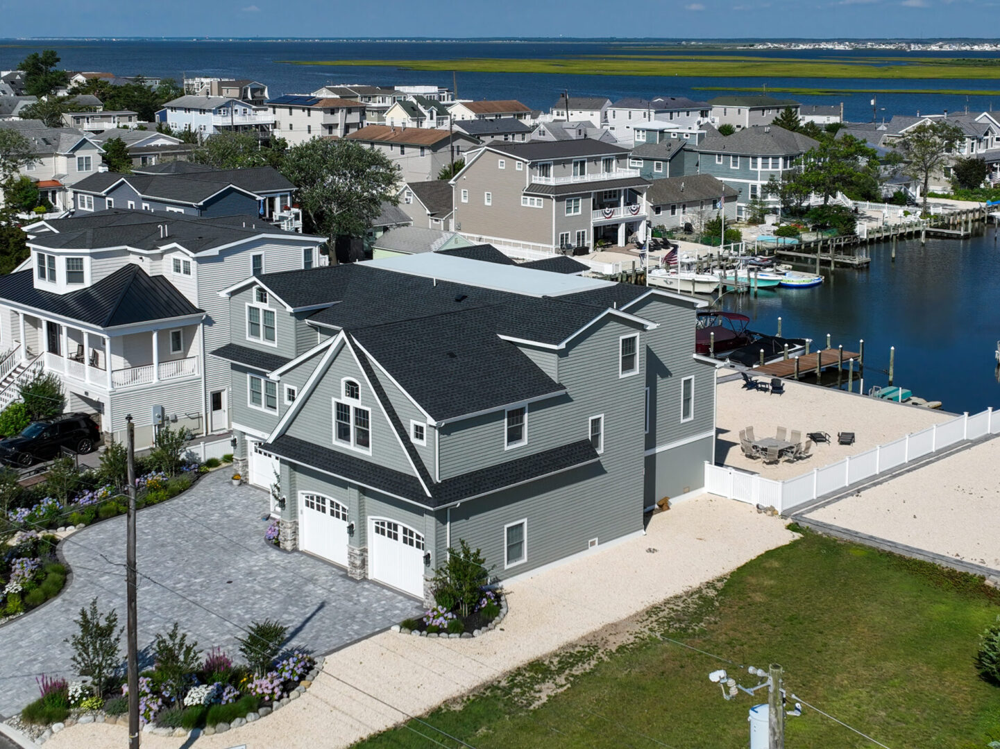 A large house with two garage doors and a dock.