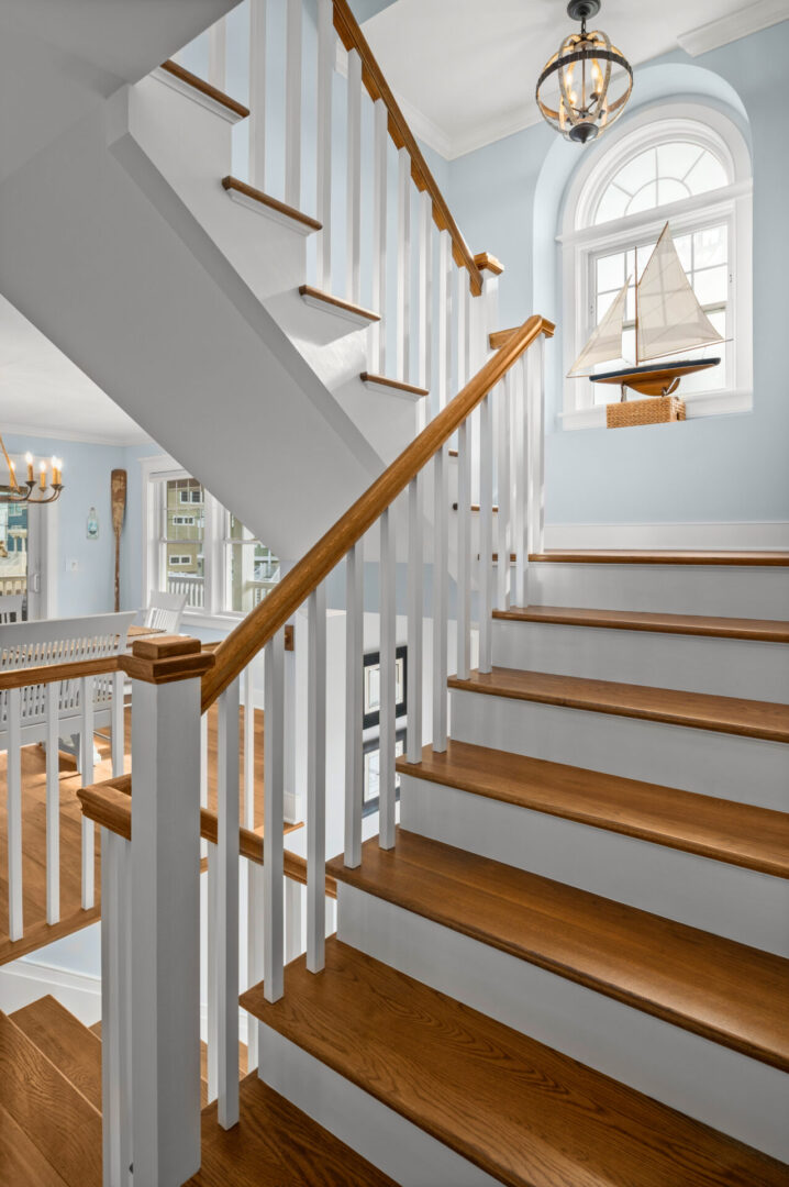 A staircase with wooden steps and white railings.