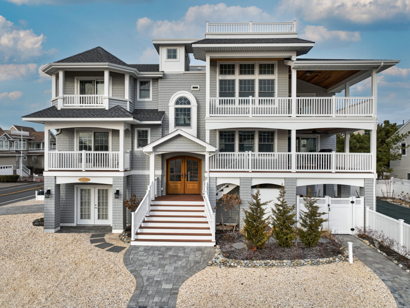 A large white house with steps leading to the front door.