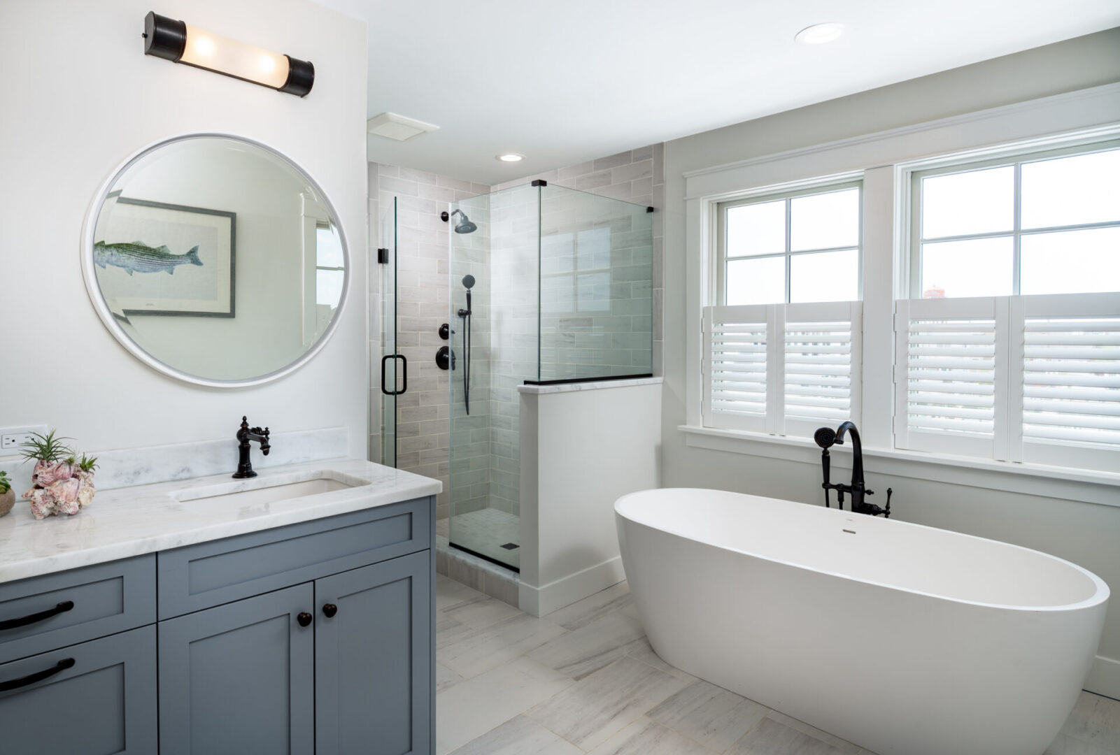 A bathroom with a large mirror and a tub.