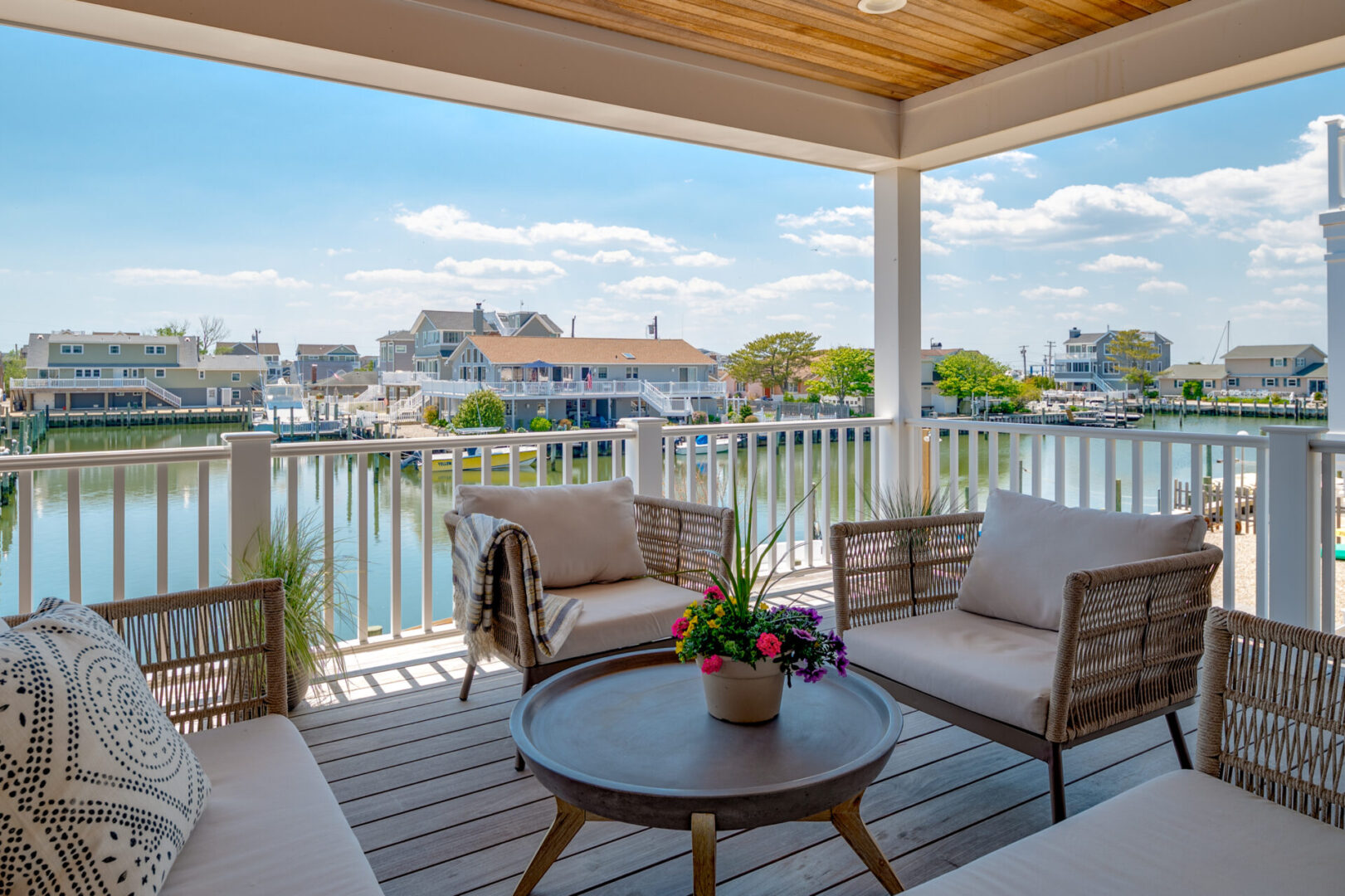 A patio with chairs and tables on the deck