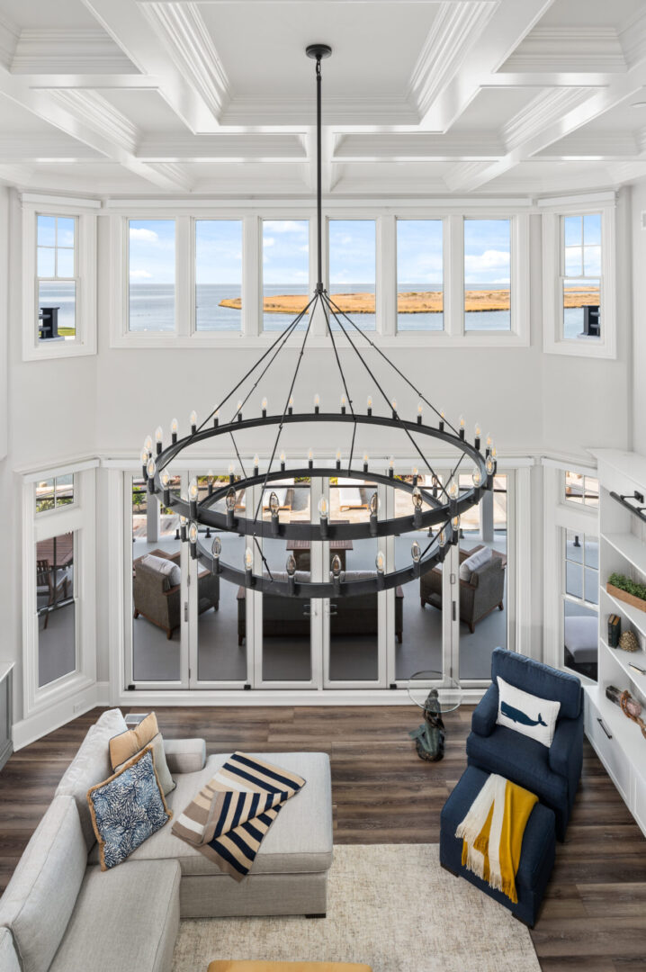 A living room with a large chandelier and open floor plan.