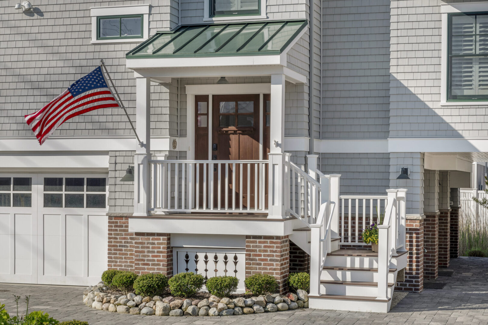 A house with a flag on the front porch.