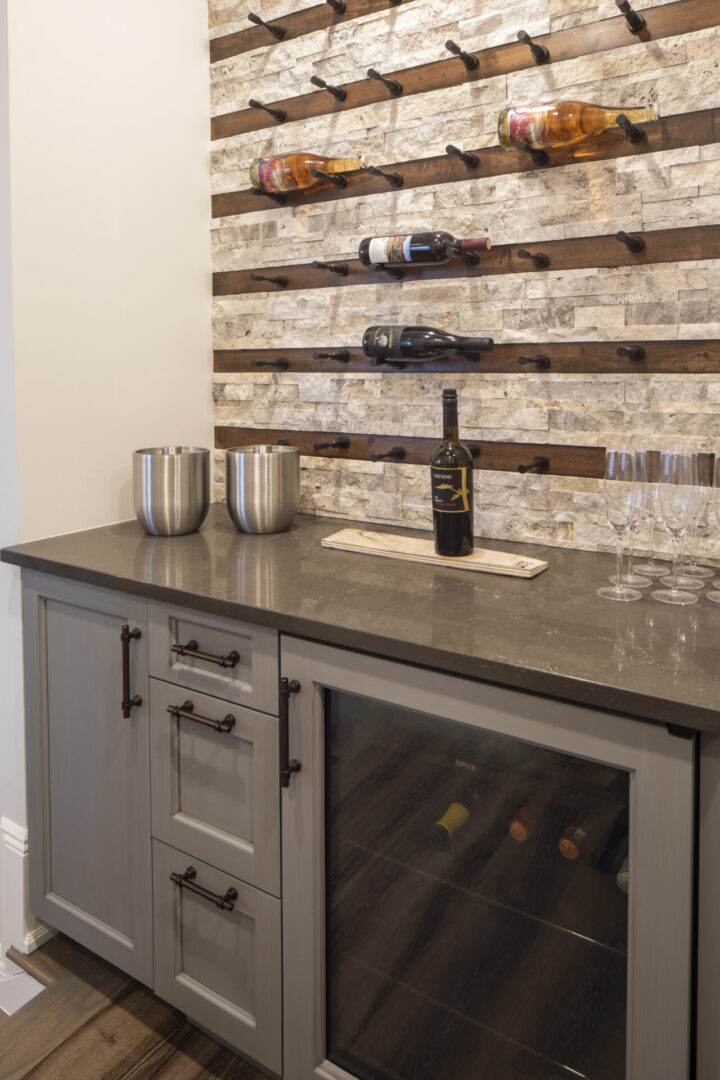 A wine cellar with a sink and bottle of wine.