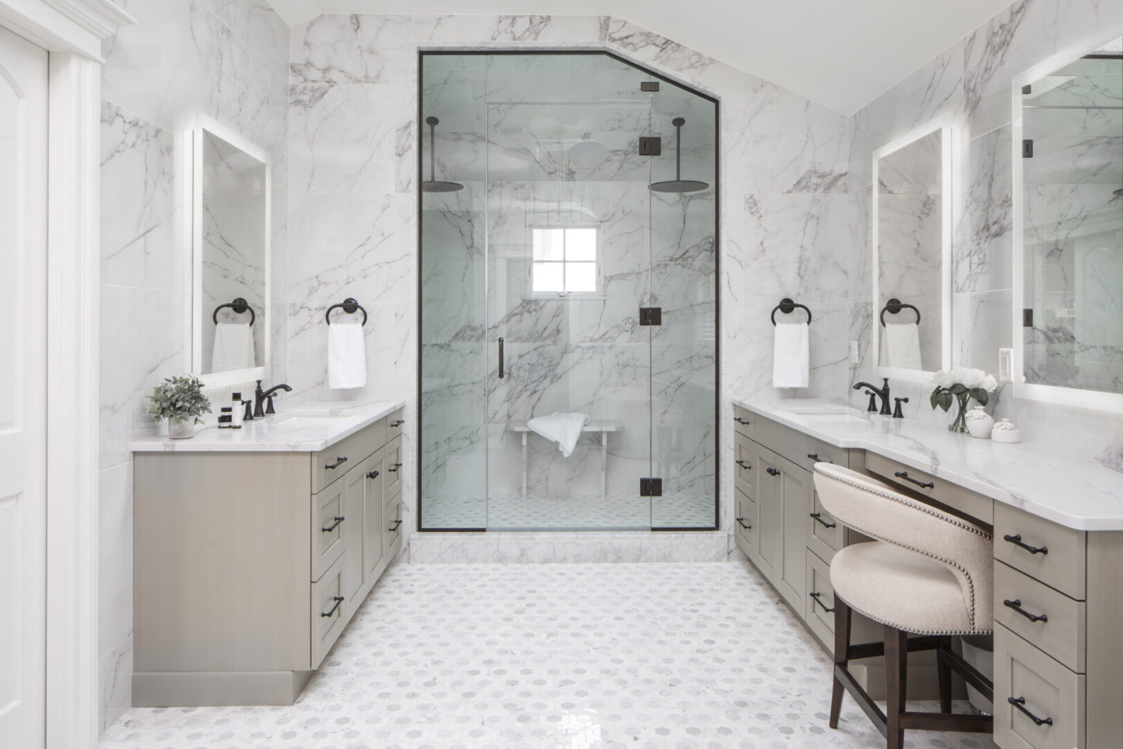 A bathroom with two sinks and a large shower.